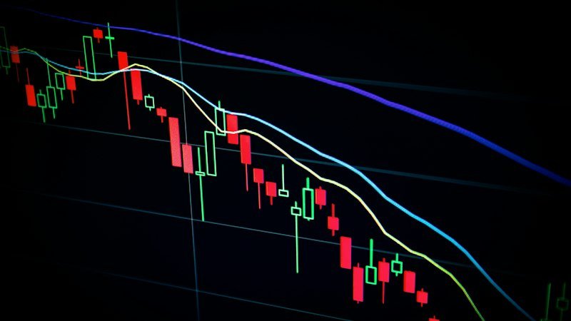 Stock market trading floor showing green upward trending charts